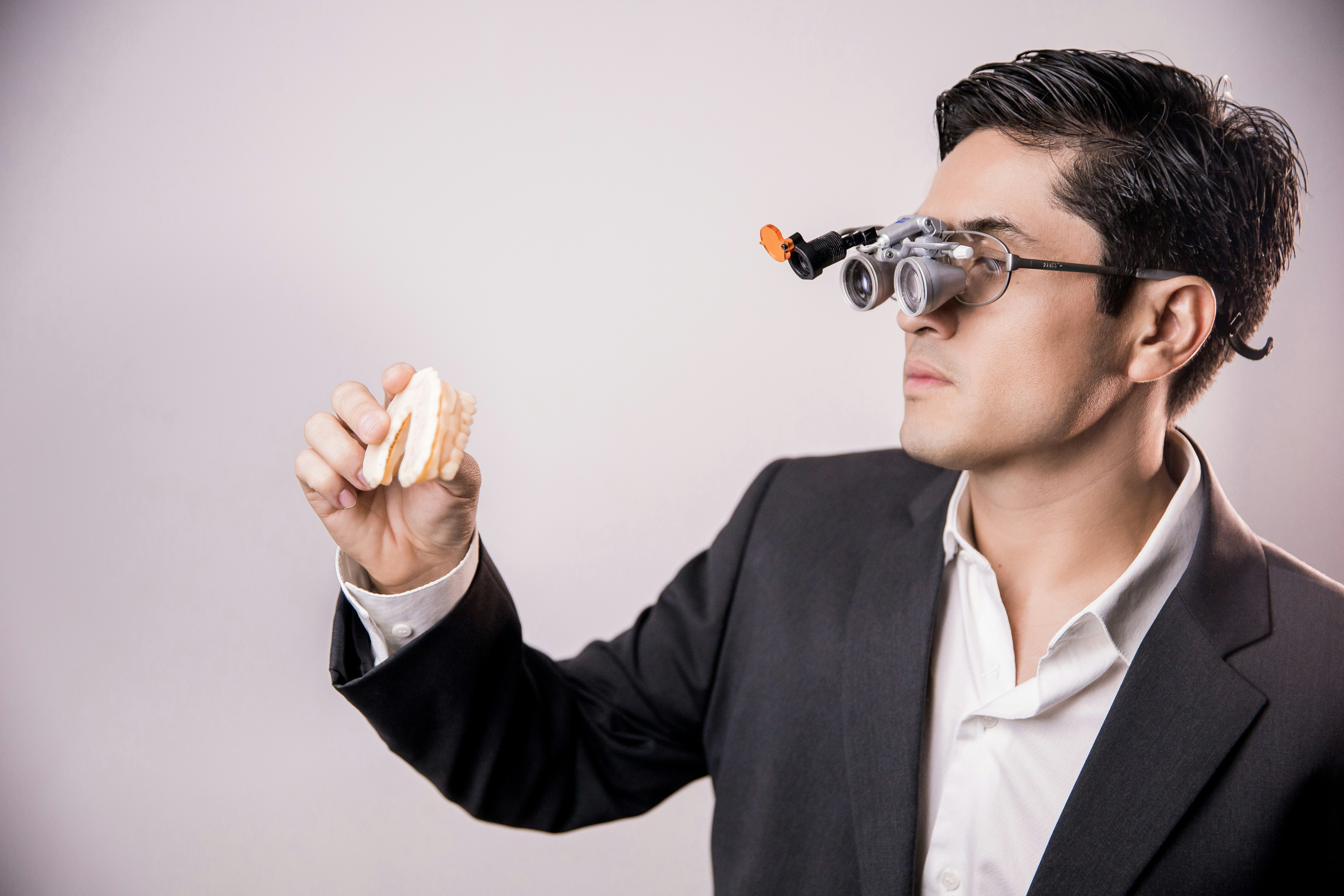 man in black suit jacket holding brown bread